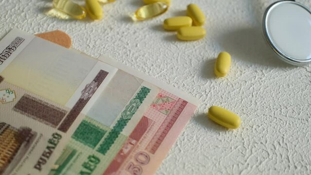 Vitamin pills, band-aids, belarus money and medicines,	