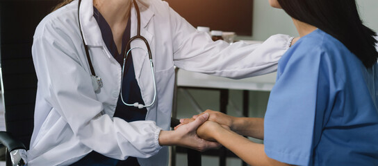 Female doctors shake hands with patients encouraging each other To offer love, concern, and...