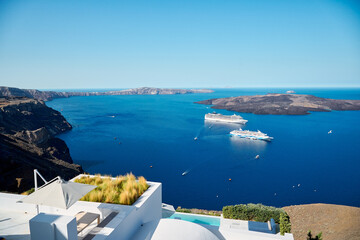 View with cruise ships of the volcanic caldera of Nea Kameni from the village of Thira (Fira),...