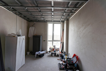 Workers are installing plasterboard (drywall) for gypsum walls in apartment is under construction, remodeling, renovation, extension, restoration and reconstruction