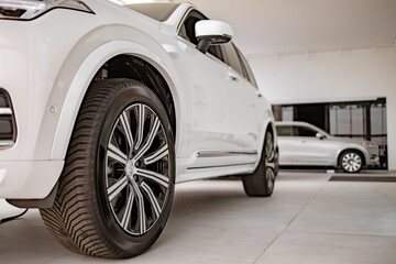 Car showroom. Aluminum wheel with tire. Rims. Automotive motor corporation manufacturer.