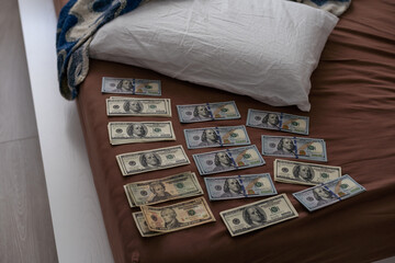 Crime scene, physical evidence. Gun handcuffs, money, dollar on a dark background.