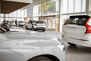 Exterior of new brand fully electric suv car in light dealership. Battery charger in white electric...