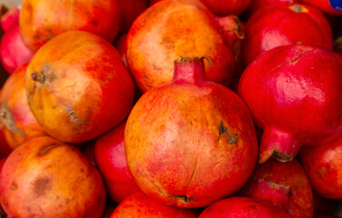ripe pomegranates close up, food natural background. harvest and market.