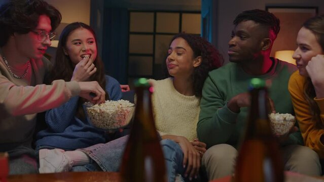 Group eating popcorn while talking about plans for holidays