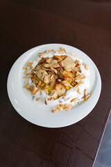 chicken shawarma rice with yogurt sauce and roasted almonds