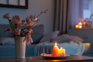 home interior with spring flowers and burning candles - 786165227