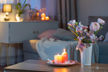 home interior with spring flowers and burning candles - 786165232