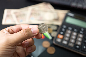 100 Yen coin, a Japanese currency. vacation, planning budget. travel plan concept. Financial...