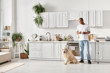 African American man with myasthenia gravis stands in kitchen with Labrador, showcasing diversity...