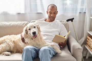 A man with myasthenia gravis relaxes at home on a couch with his loyal Labrador dog, engrossed in a...