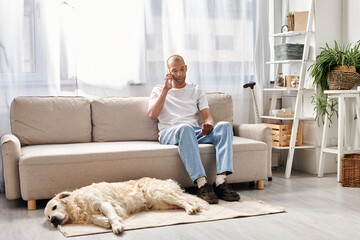 An African American man with myasthenia gravis sits on a couch, accompanied by his loyal Labrador...