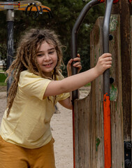 Obraz premium Radiant childhood: Warm day, long blonde haired boy plays and smiles