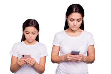 Close up photo beautiful two people brown haired mom small little daughter addicted telephones writing sms each other not see close attentive wear white t-shirts isolated bright blue background