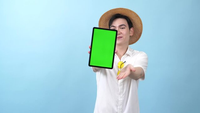 Young Asian man on blue background