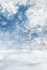 Snowdrifts in the forest. Winter landscape. Falling snow on a blurred background of trees and blue...