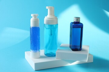 Set of luxury cosmetic products on light blue background