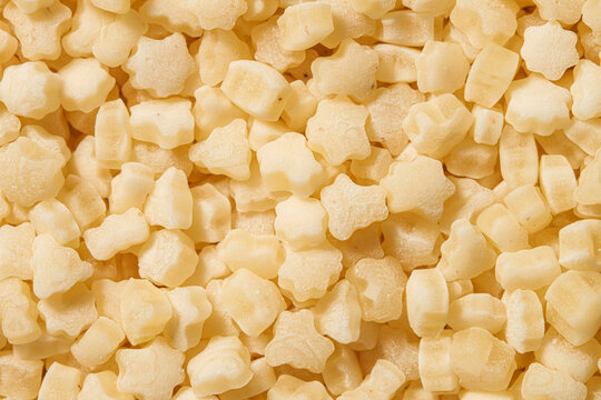 Close-up macro shot of dry pasta without eggs, tarhonya. Texture. Background.