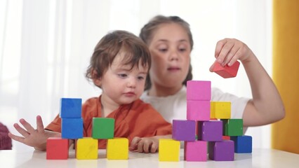 child baby group playing cubes close-up. education a children development of fine motor skills concept. child baby group close-up hands plays with lifestyle blocks develops fine motor skills