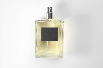 Luxury men's perfume in bottle on white background, top view