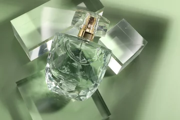 Fotobehang Stylish presentation of luxury perfume in sunlight on olive background, above view © New Africa