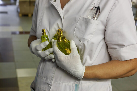 Production of perfume factory in a woman hands.