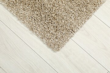 Soft beige carpet on white laminated floor indoors, top view. Space for text