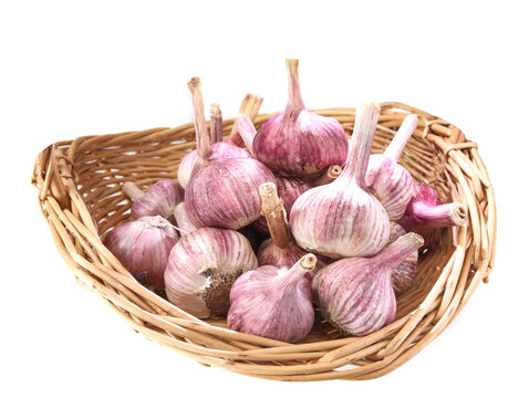 A basket of garlic on white background