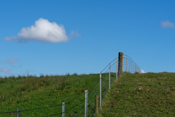 Wire fence over the brow of a hill