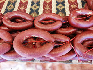 Natural delicious smoked Turkish sausage soсuk in bagels on the shop window