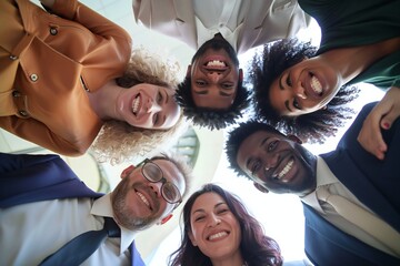Happy diverse team having fun together. Low angle group portrait of cheerful joyful young and senior Caucasian and African American business people friends huddling, looking down at camera and smiling - Powered by Adobe