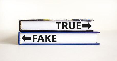 True or fake symbol. Concept word True or Fake on beautiful books. Beautiful white table white...