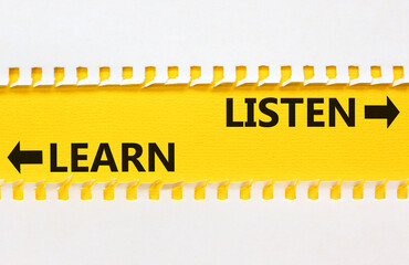 Listen and learn symbol. Concept word Listen and Learn on beautiful yellow paper. Beautiful white...