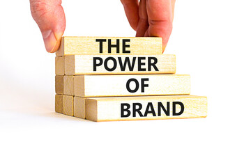 The power of brand symbol. Concept words The power of brand on beautiful wooden block. Beautiful white table white background. Businessman hand. Business the power of brand concept. Copy space.