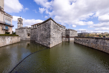 An old historic building in the city of Havana in Cuba showing the castle surrounded by a moat