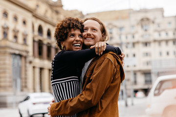 Embracing couple enjoying a romantic walk in the urban streets