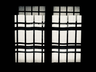 window with iron grates seen against the light