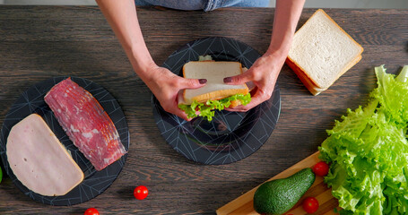 Making sandwich food top view. Lettuce and ham sandwich.