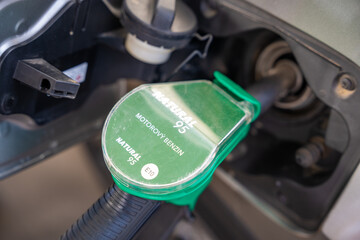 A car being refueled at petrol or gas self-service filling station in Europe