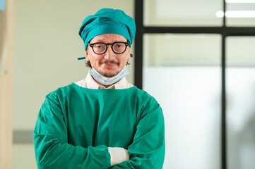 Man male surgeon doctor portrait in Green coat gown with stethoscope, waist up. Medical senior...