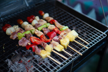 BBQ, grilled on a charcoal grill and brushed with sauce.