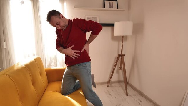 Man with hip, back and sciatica pain at home.