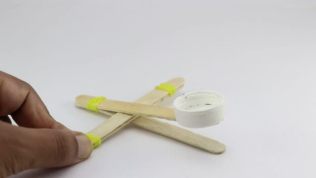 Mini catapult model made using ice cream stick and uses elastic band