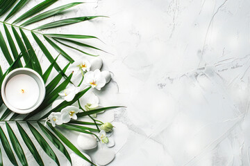 Spa concept on white stone background, palm leaves, flower, candle.