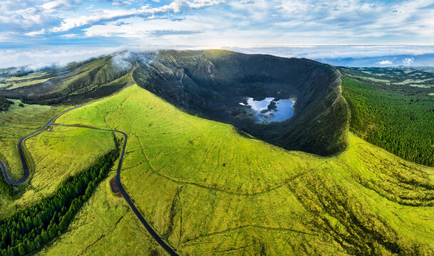 Fototapeta Azores, Faial island - Aerial view from drone to green volcano Caldeira at sunrise, Portugal