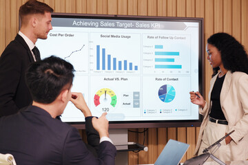A businessman stands and presents a business plan in a conference room.