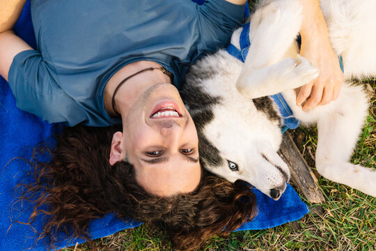 Horizontal photo upside-down world of fun with a man and his husky. Lifestyle concept.