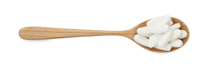 Vitamin pills in wooden spoon isolated on white, top view. Health supplement