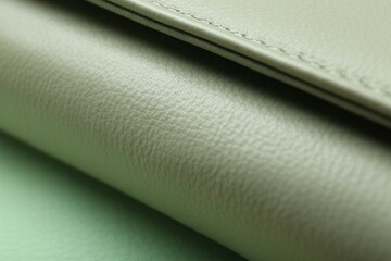 Green leather with seam on table, closeup