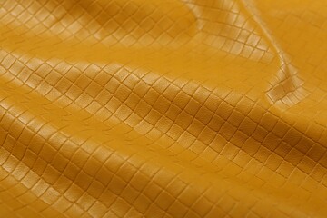 Beautiful yellow leather as background, closeup view